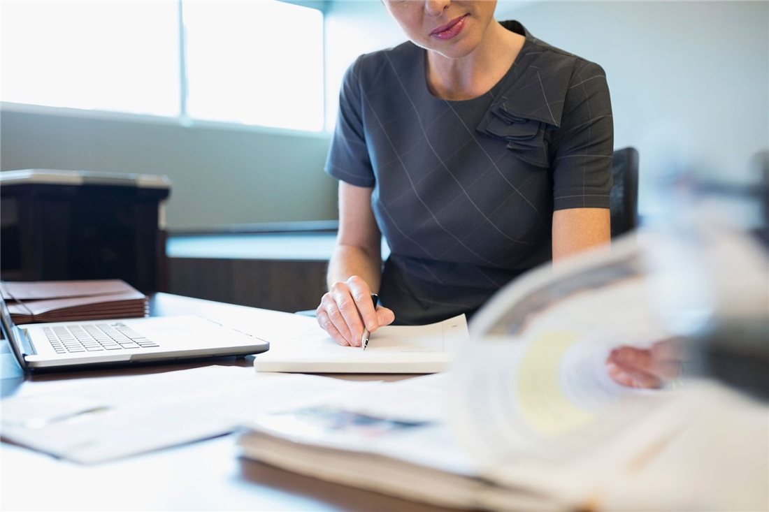 Solicitor reviewing case documents at a desk